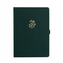 Dark green notebook with a gold floral design on a white background